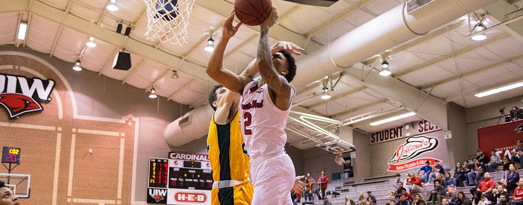 Basketball players compete on the court