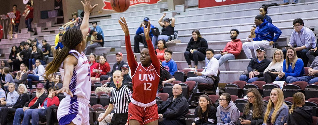 Women's basketball players compete on the court