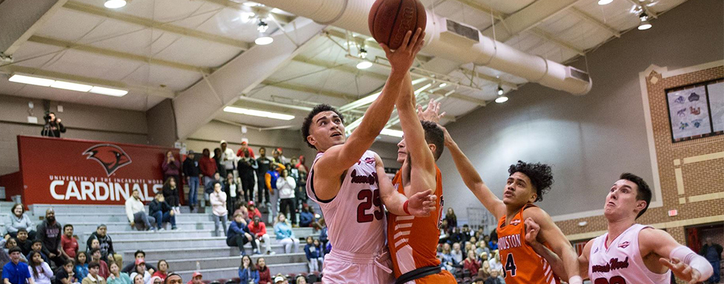 Basketball players compete on the court