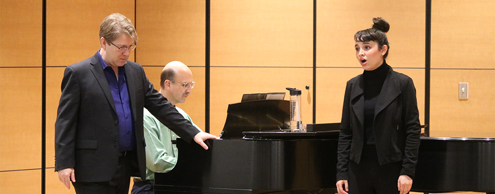 A students performs on stage and receives feedback from Daniel Belcher