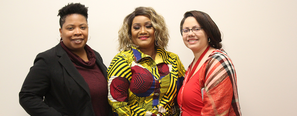 A group of three women pose for a photo together