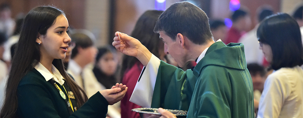 A student receives Holy Communion 