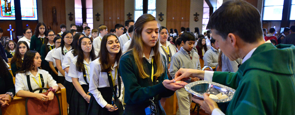Students wait in line to receive Communion 