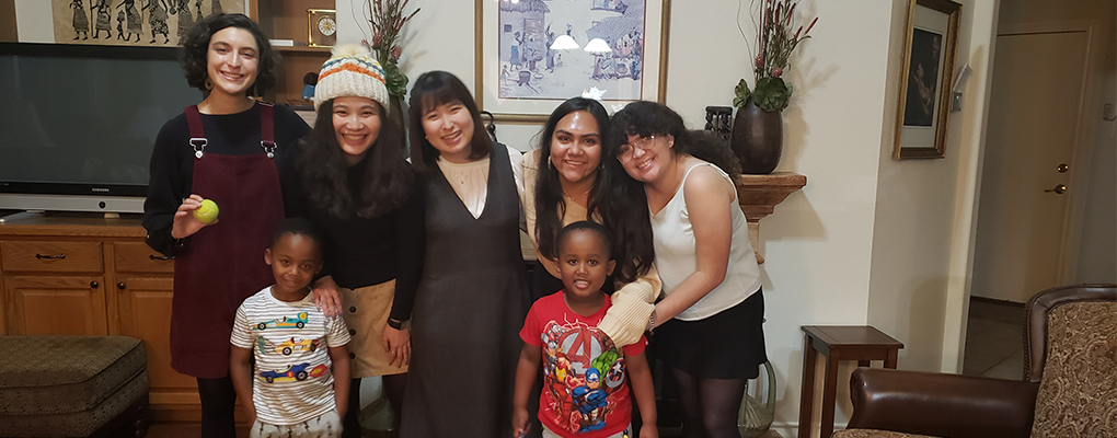 UIW students pose for a photo with two young children