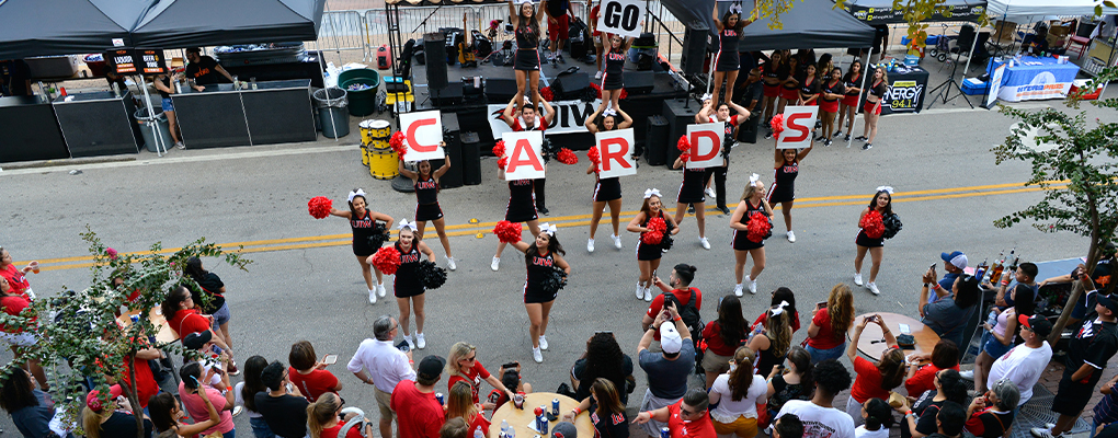 UIW cheerleaders perform a cheer in front of a crowd of people