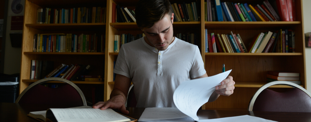 A student sits at a desk and studies