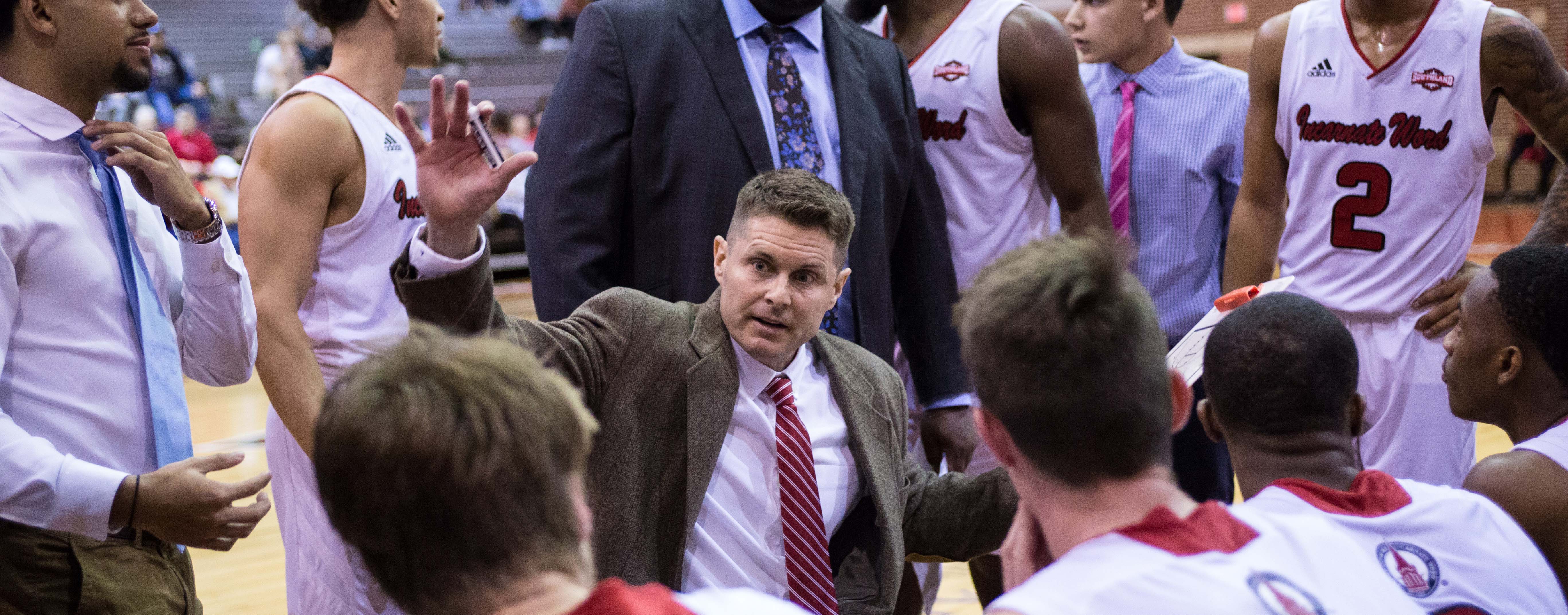 Coach Cunningham gives instruction in a team huddle