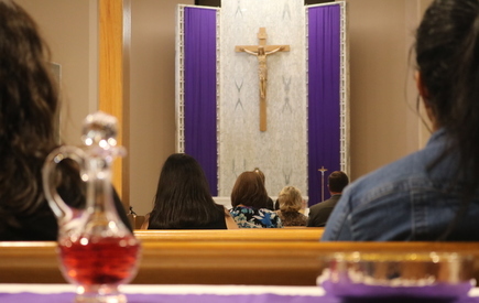 People sit in a chapel during Mass