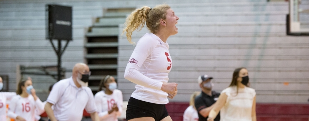 A volleyball player celebrates on the court