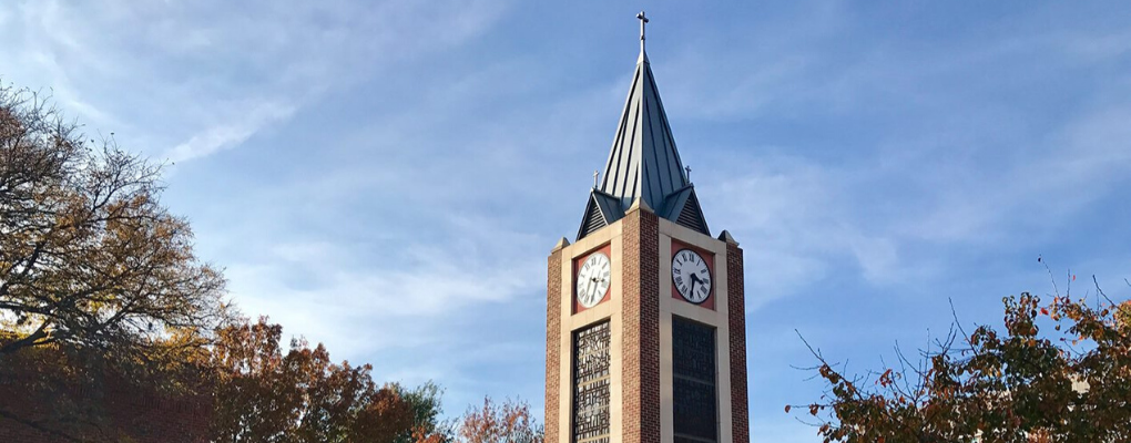 The UIW clock tower against a blue sky