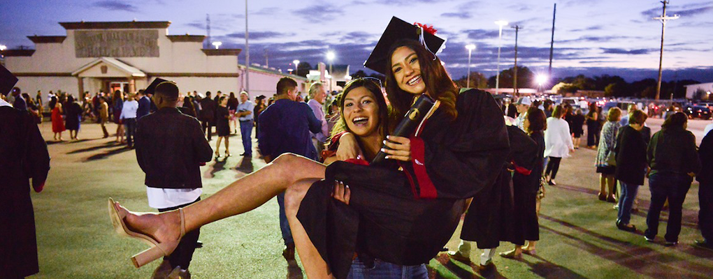 A UIW graduate is lifted by her friend