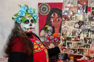 A woman in Dia de los Muertos makeup