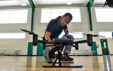 A student inspects a drone