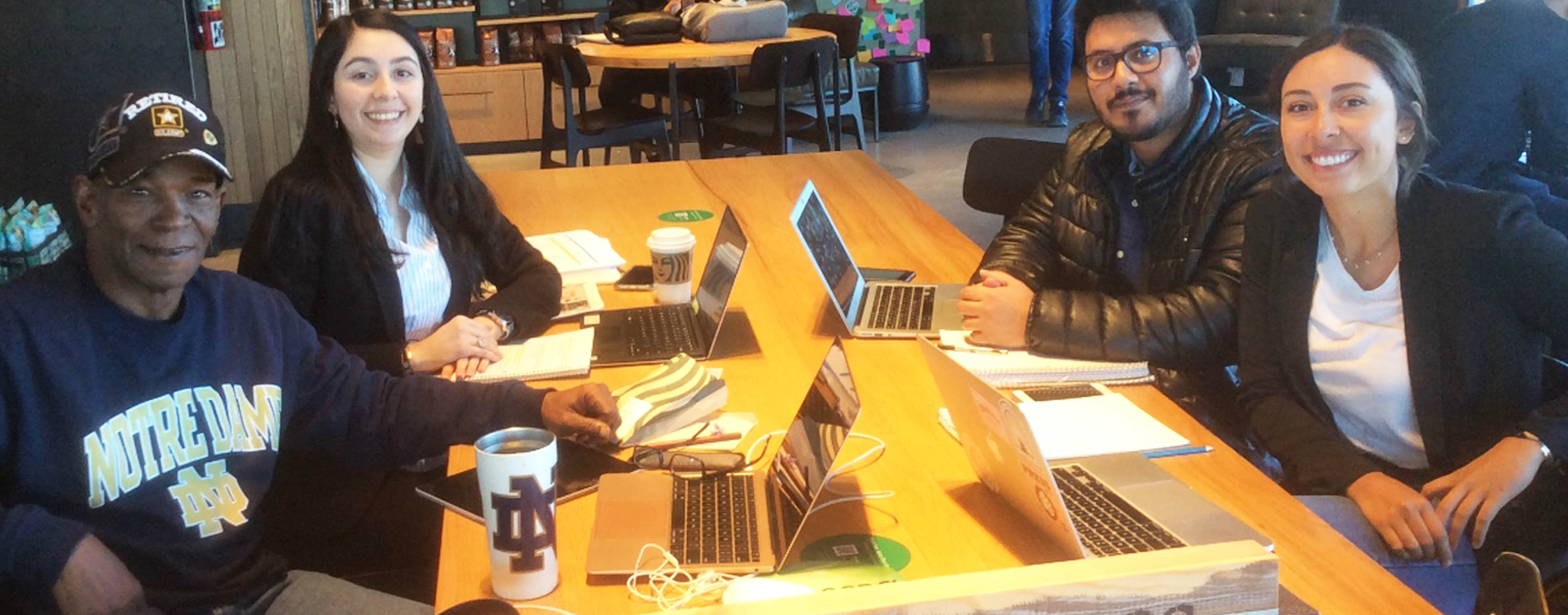 A group of students sit around a table