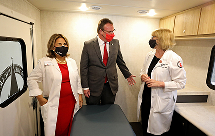 UIW leadership stand inside the mobile medical unit