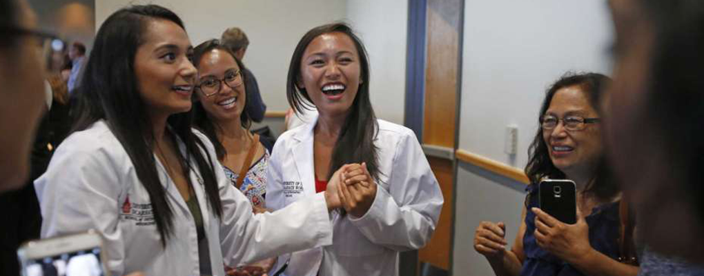 UIW medical students stand together, converse and laugh