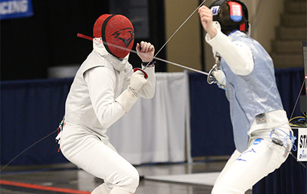 Two fencers compete in a match