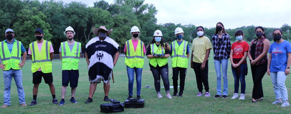 The UIW Flight Team stands in a field ready to fly a drone
