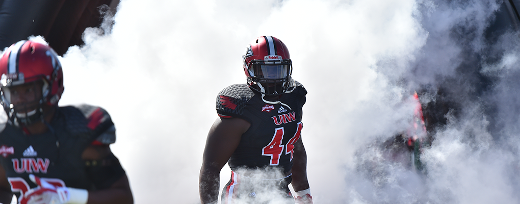 UIW football player runs onto football field