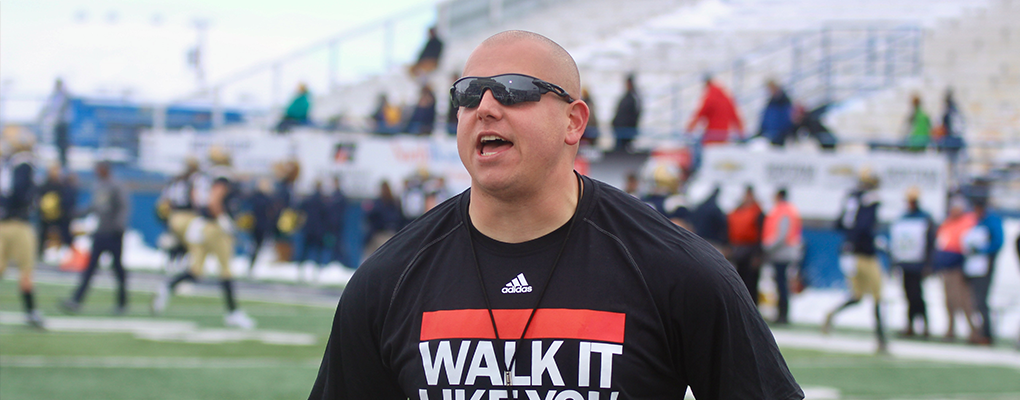 Bret Huth coaches on the field