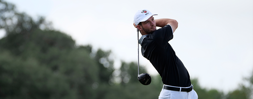 A student plays golf