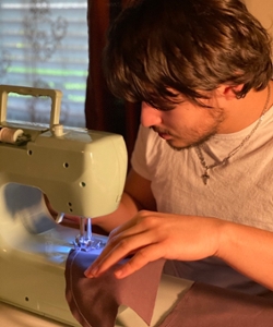 A student uses a sewing machine