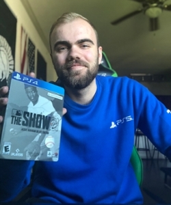 Joshua McMullen holds a copy of the video game he helped create