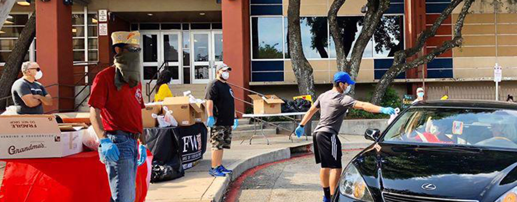 Volunteers bring items to a vehicle