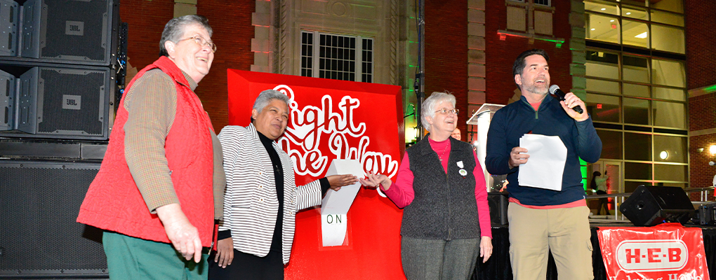 Three Sisters flip a giant, red light switch 