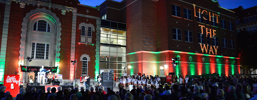 UIW campus buildings are lit up and people are gathered around 