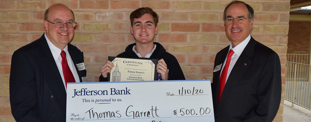 A student is presented with a large check