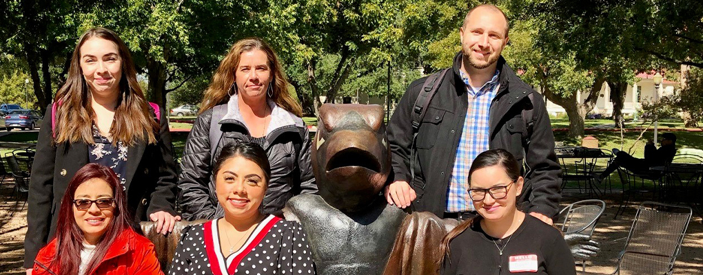 UIW employees sit on a bench