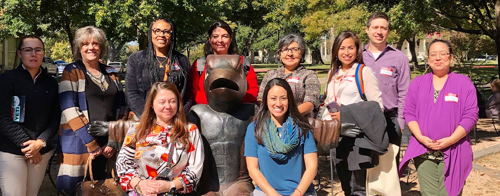 UIW employees sit at a desk