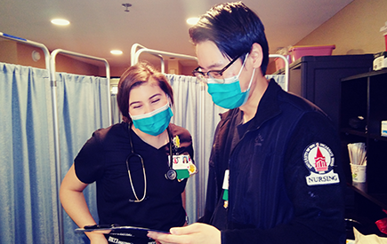 Two nursing students at work