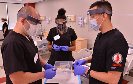 Three nursing students stand together