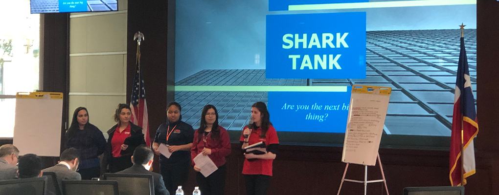 Students present their business ideas to a room of people