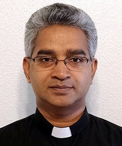 A headshot of Rev. Thomas Thennadiyil