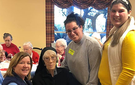 Four women pose for a photo together