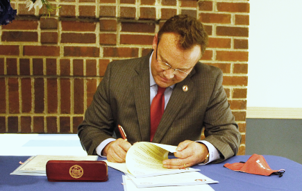 Dr. Evans signs documents