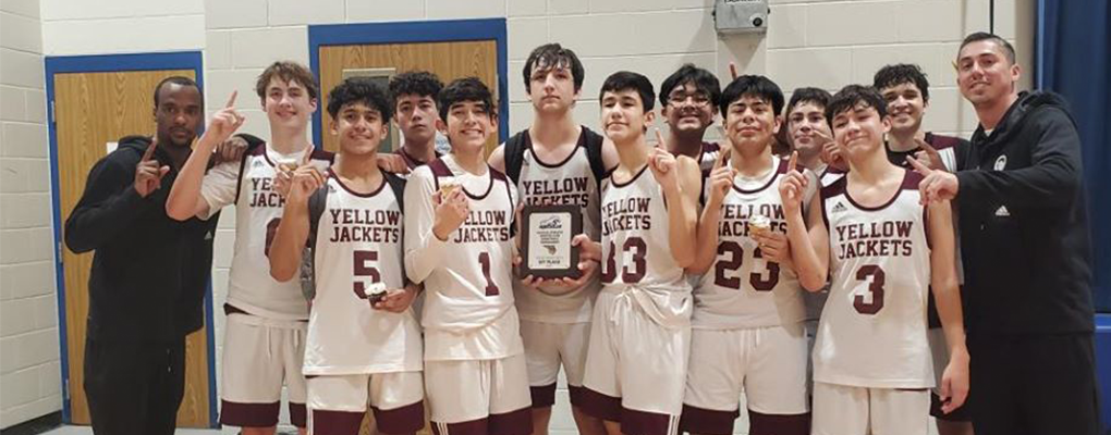 A basketball team poses for a photo together