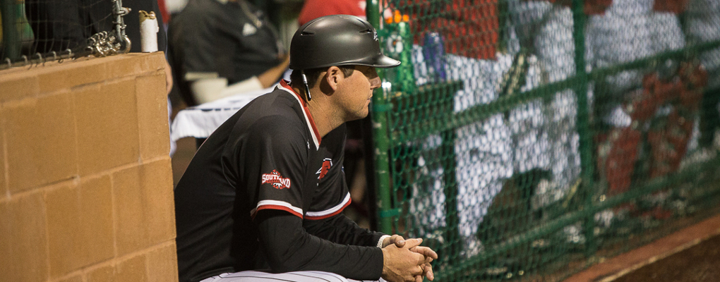 UIW baseball coach sits looking out on the field