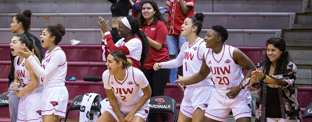 UIW women's basketball team members cheer on the sidelines
