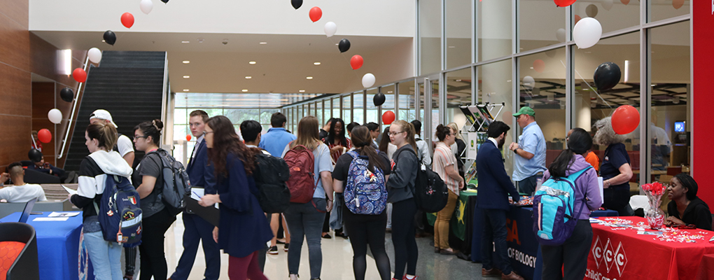 A crowd of people attend a career fair.