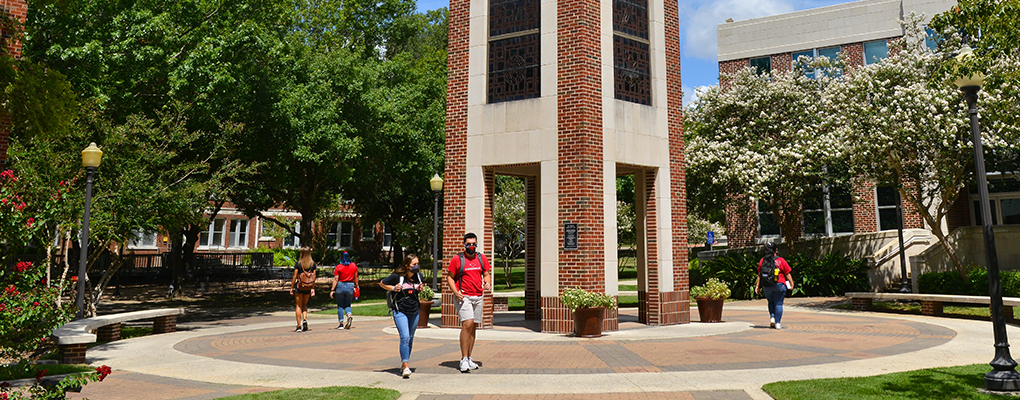 Students in masks walk on campus