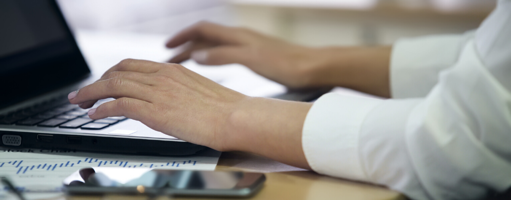 A person types on a computer