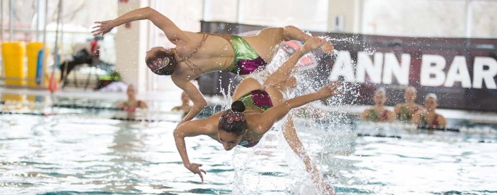 Two synchronized swimmers perform