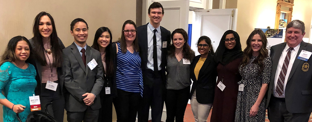 A group of people pose for a photo together at a medical conference