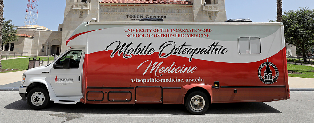 The UIWSOM Mobile Osteopathic Medicine unit parked in front of the Tobin Center