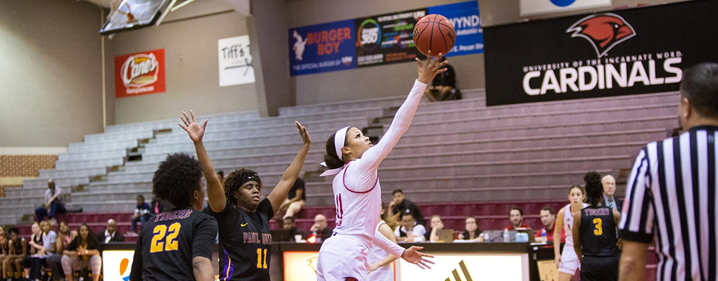 Women's basketball players compete at a game