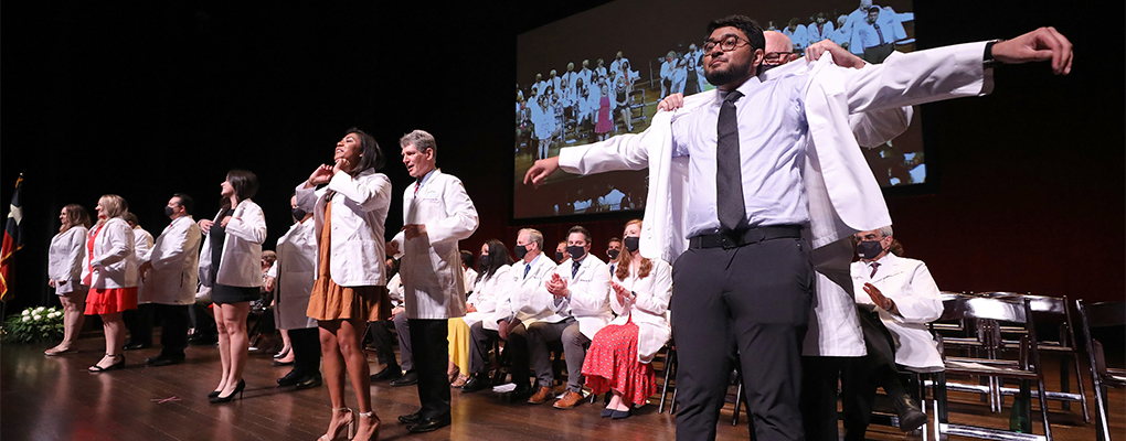 Students receive their white coats